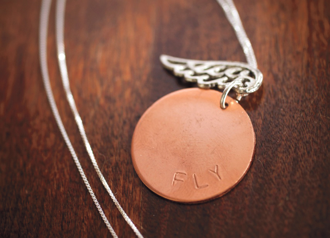 Created by Christy Bourns of Robinson Lane, this necklace features a large copper disc hanging next to a pewter accent on an 18” sterling silver chain.