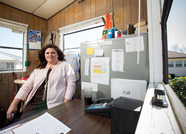 Janis Newberry sits in the guard shack at Our House, a place where she worked while living there.